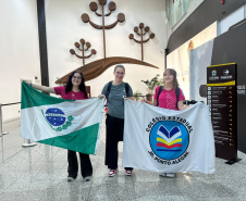estudantes apresentam bandeiras do Paraná e da escola na despedida.