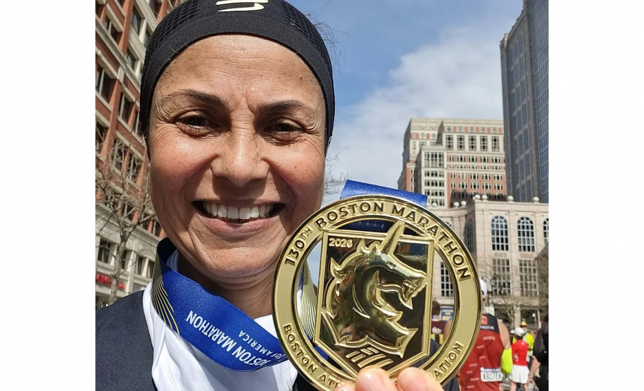 Marcia Simoni, servidora da SEES, com a medalha da Maratona de Boston