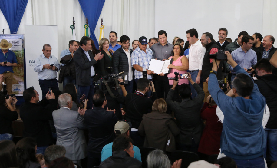 Cinquenta e seis famílias de produtores rurais ocupantes de terras pertencentes ao Estado (devolutas) em Pitanga e Boa Ventura do São Roque, no Centro do Paraná, receberam nesta sexta-feira (7) os títulos de propriedade de seus imóveis. Aguardado há anos pelas famílias, o documento de regularização das terras foi entregue em encontro com o governador Carlos Massa Ratinho Junior, realizado em Pitanga.   Foto: José Fernando Ogura/ANPr