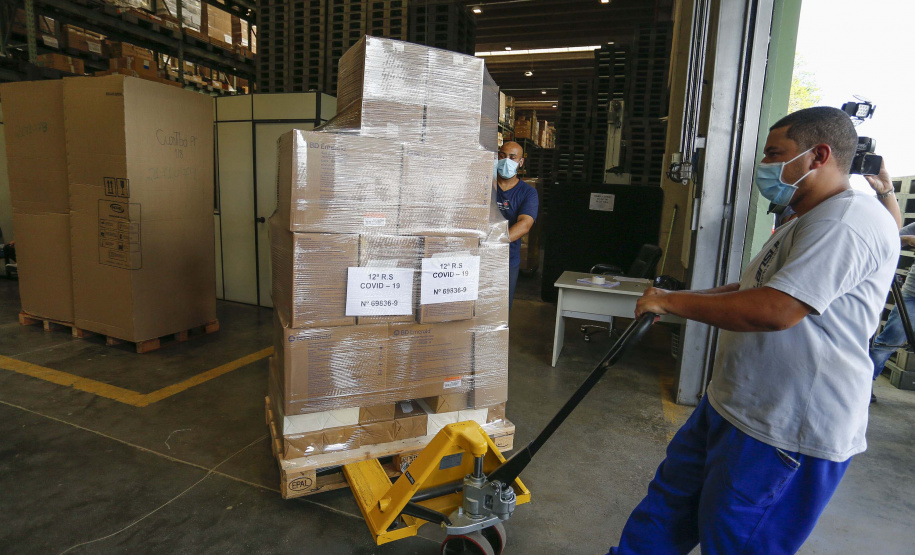 A Secretaria da Saúde do Paraná vai dar início neste sábado (16) à distribuição da primeira remessa de insumos destinados à vacinação da Covid-19 no Estado. Quatro caminhões vão sair pela manhã da central de abastecimento e suprimentos da secretaria, no Jardim Botânico, em Curitiba, carregados com 2,2 milhões de itens que serão entregues a 20 Regionais de Saúde do Estado. 
 Foto:Jonathan Campos/AEN