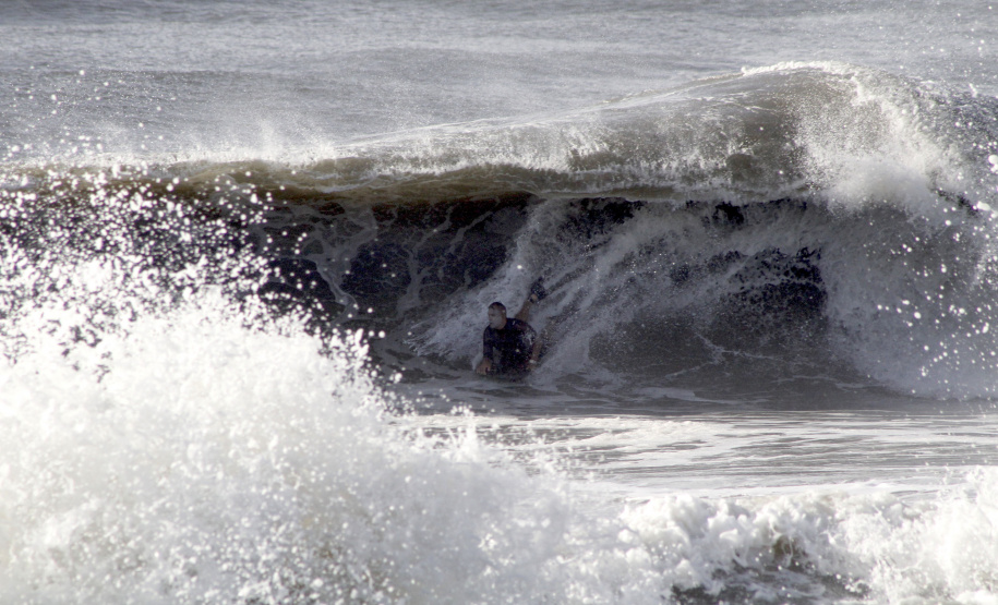 As mudanças propostas pelo Governo do Estado no projeto de recuperação a Orla de Matinhos vão ter interferência na prática do surf. Entre as intervenções, estão previstas estruturas de contenção para conter as cheias provocadas pela maré alta. -  Foto: Surfista local